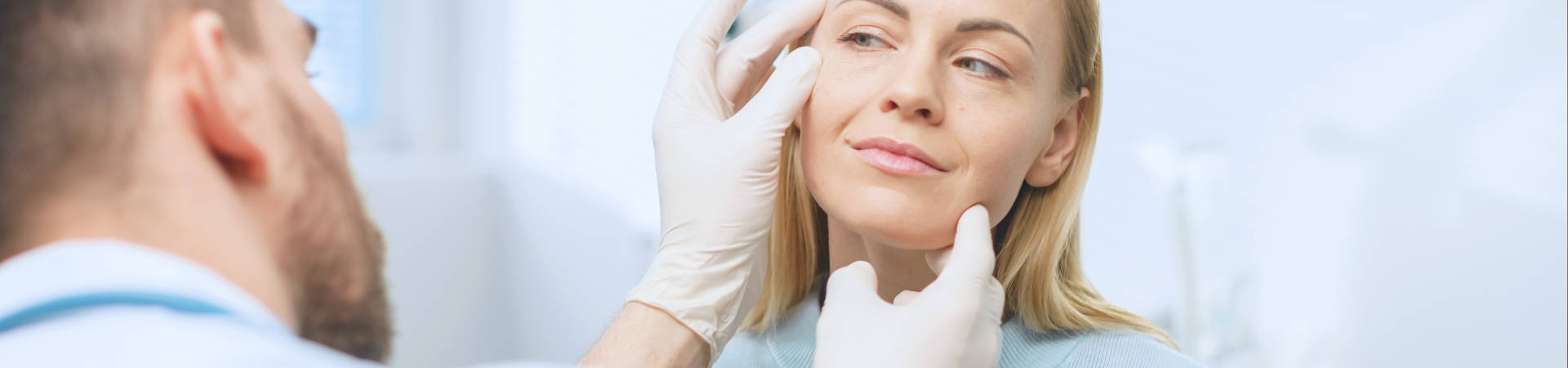 Plastic Surgeon Examines Beautiful Woman's Face