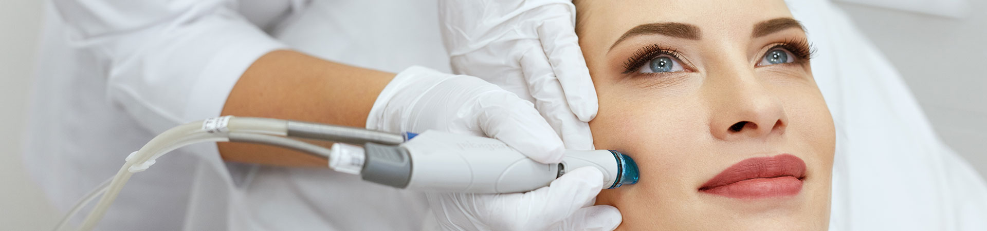 Dermatologist touching face of beautiful mature woman